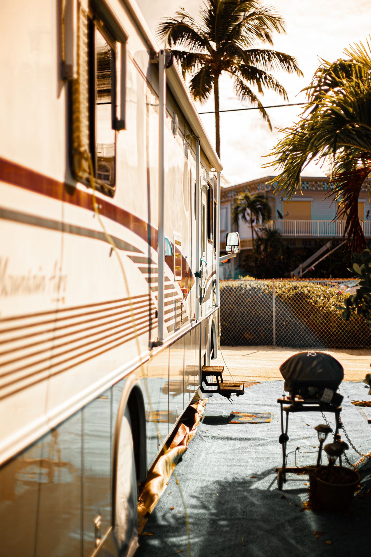 Awning side of a motorhome baking in harsh desert sunlight at an RV site